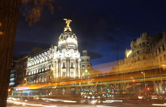 The Edificio Metrópolis lit at dusk on the corner of Gran Vía