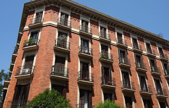 A brick apartment building with iron balconies in Barrio de Salamanca