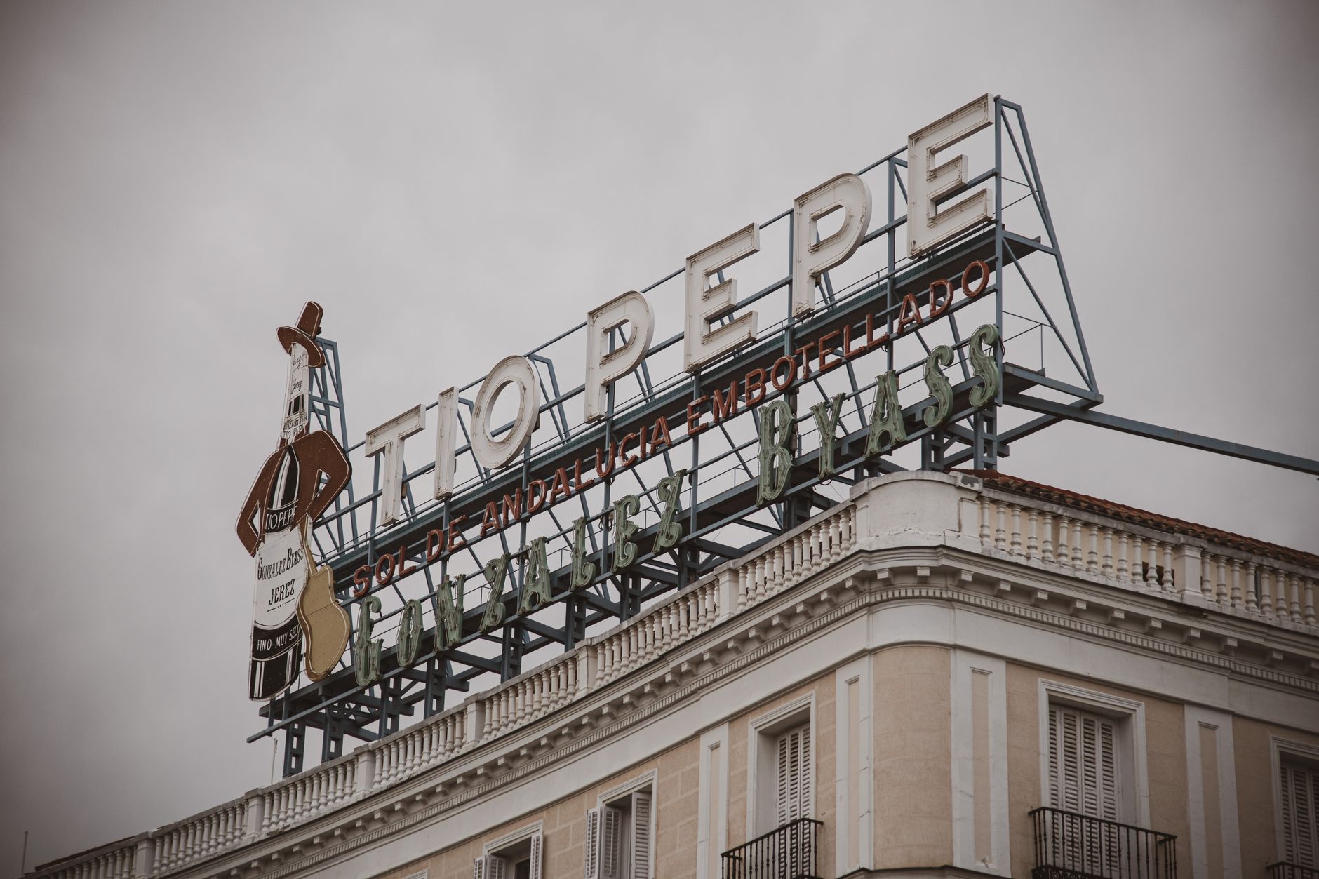 Famous Tio Pepe sign atop a building in Madrid's Puerta del Sol, an iconic city landmark. — illustrating What Is the Abono Joven, and Who Qualifies for It?