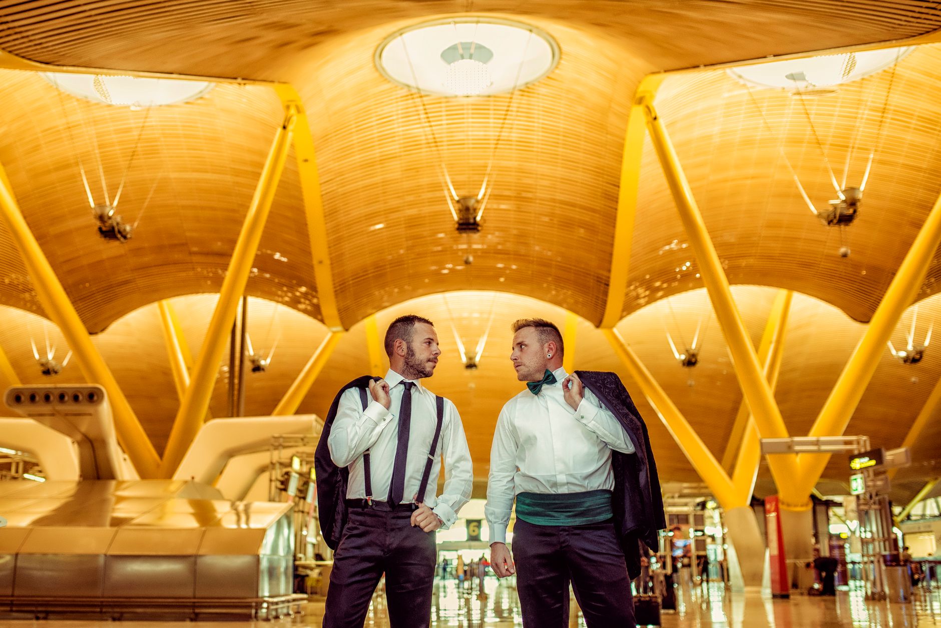 Two men in formal attire engage at the stunning Madrid-Barajas Airport. — illustrating How Do You Get From Barajas Airport Into Central Madrid?