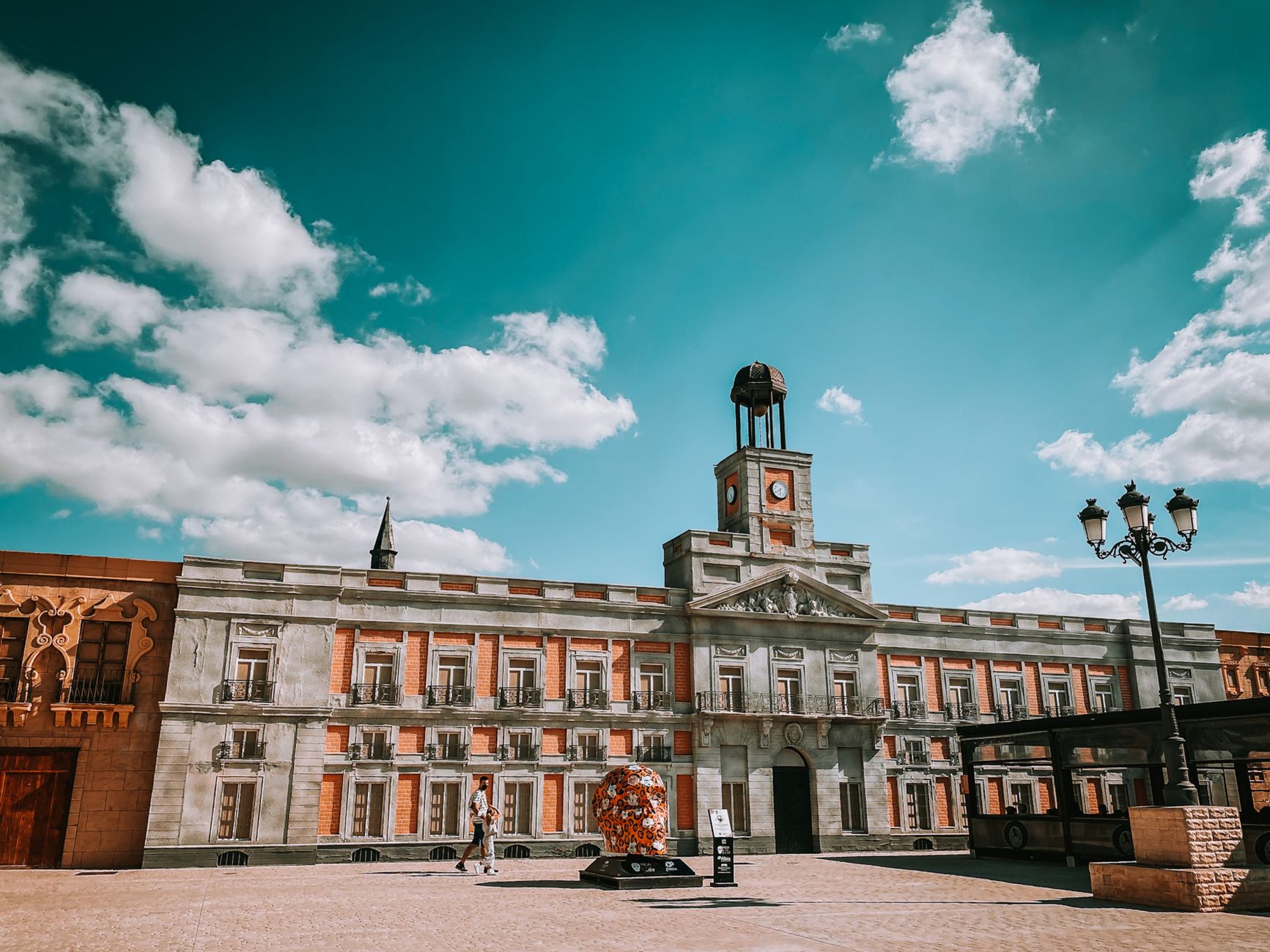 Vibrant facade of the iconic building at Puerta del Sol, Madrid, under a bright blue sky. — illustrating When Is the Best Time of Year to Visit Madrid?