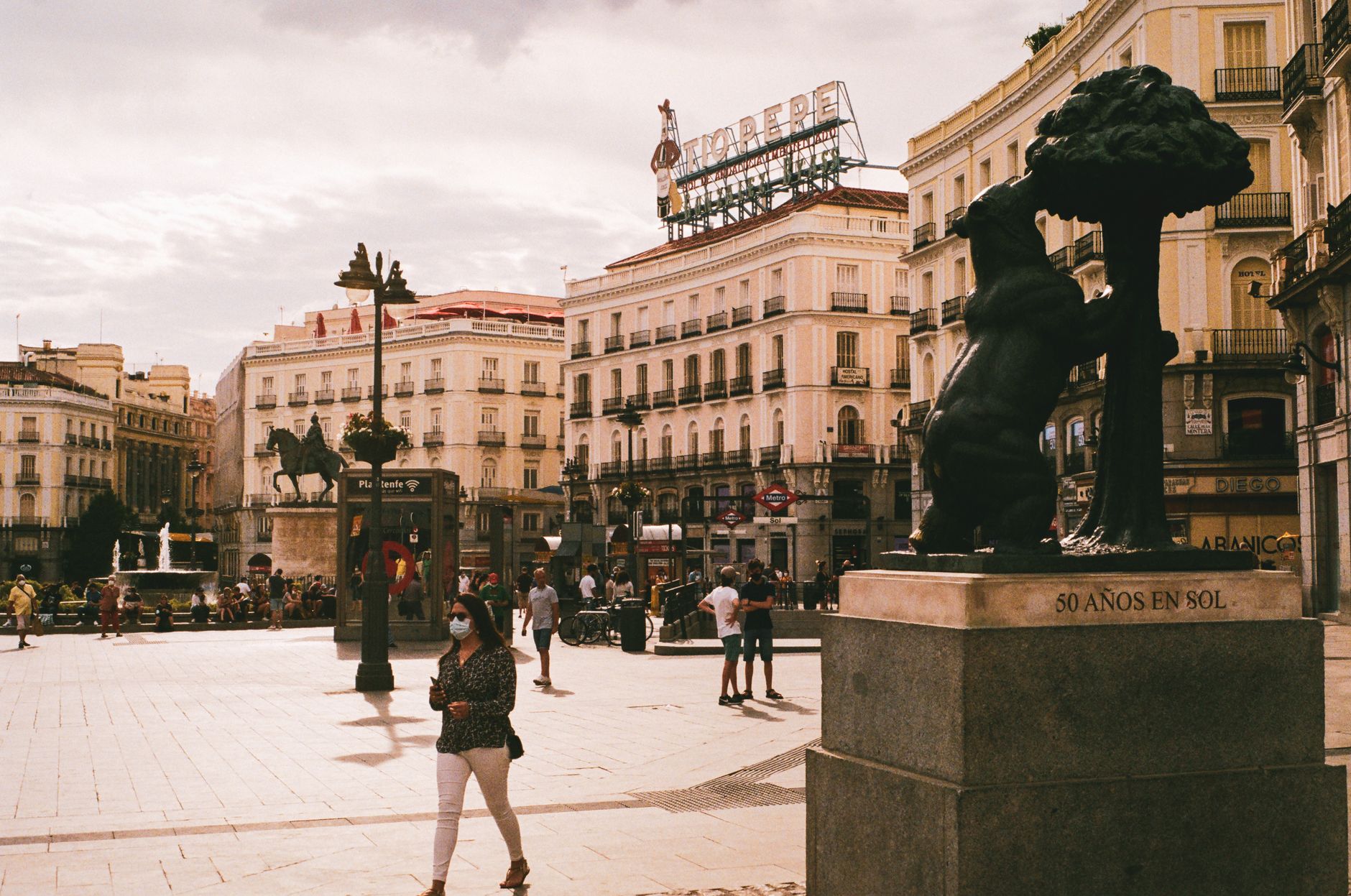 View of Puerta del Sol in Madrid showcasing the Bear and Strawberry Tree sculpture on a sunny day.