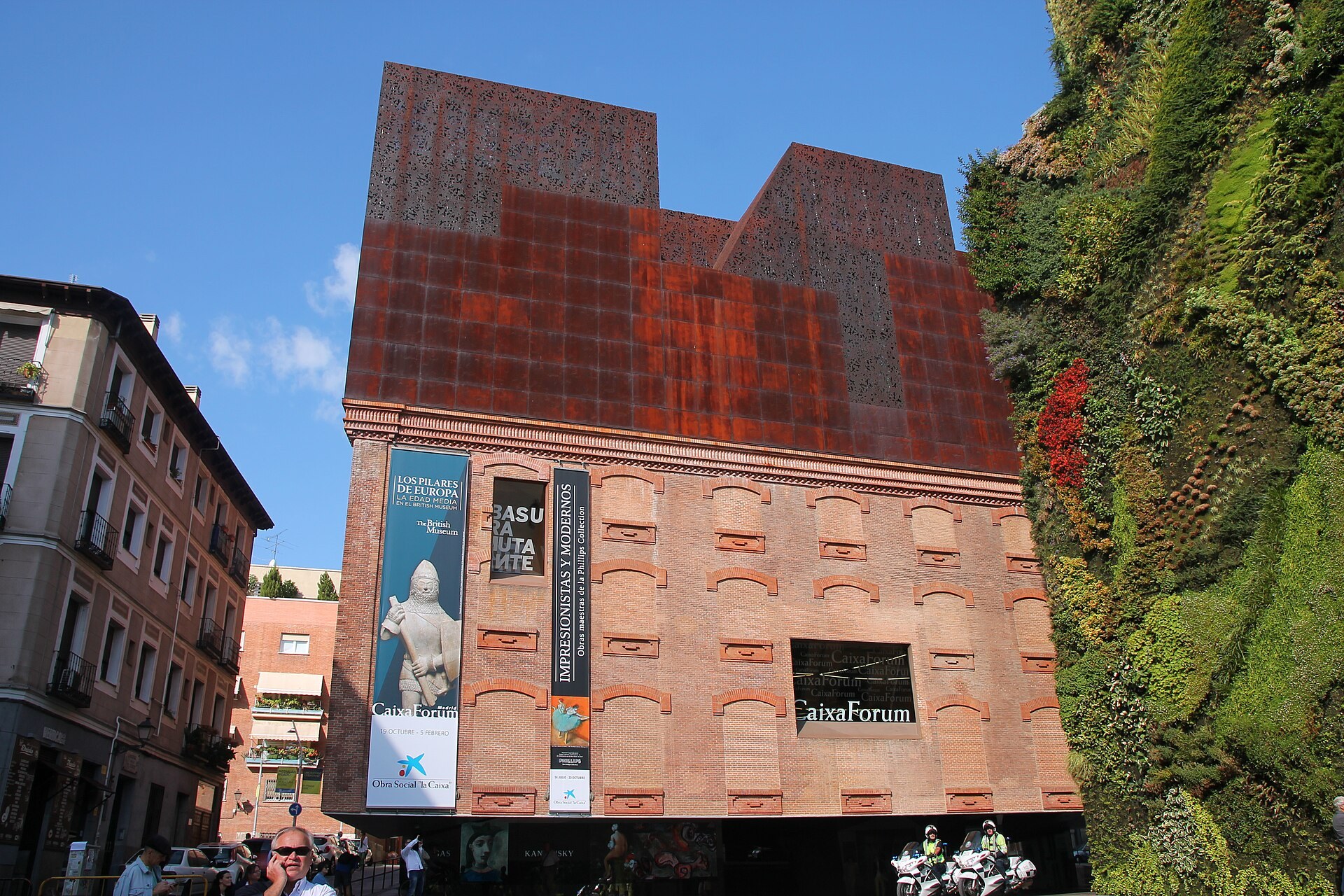CaixaForum Madrid: the old power station brick base, the rusted steel addition above it and the vertical garden alongside