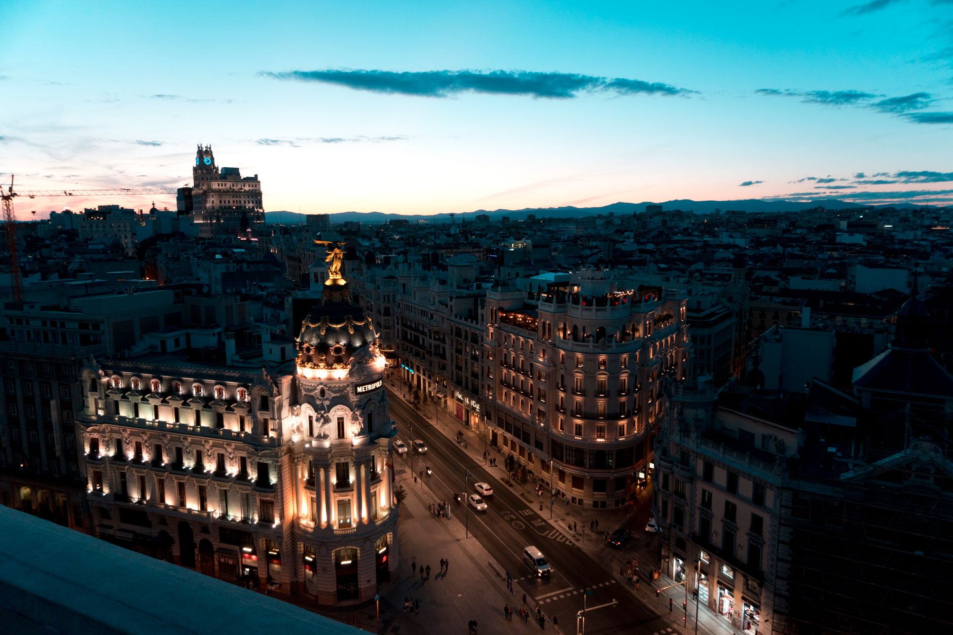 A stunning view of Madrid cityscape during twilight with beautifully illuminated buildings and clear skies. — illustrating A First Visit to Madrid, in a Sensible Order