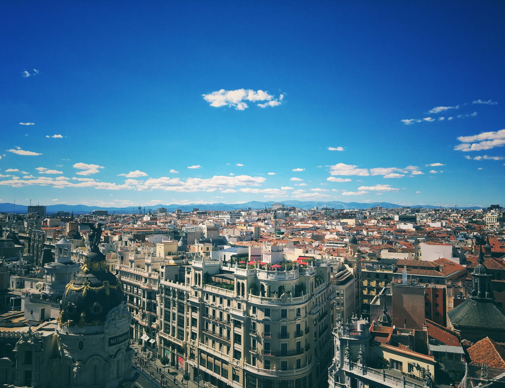 A breathtaking aerial view of Madrid's vibrant cityscape under a clear blue sky.