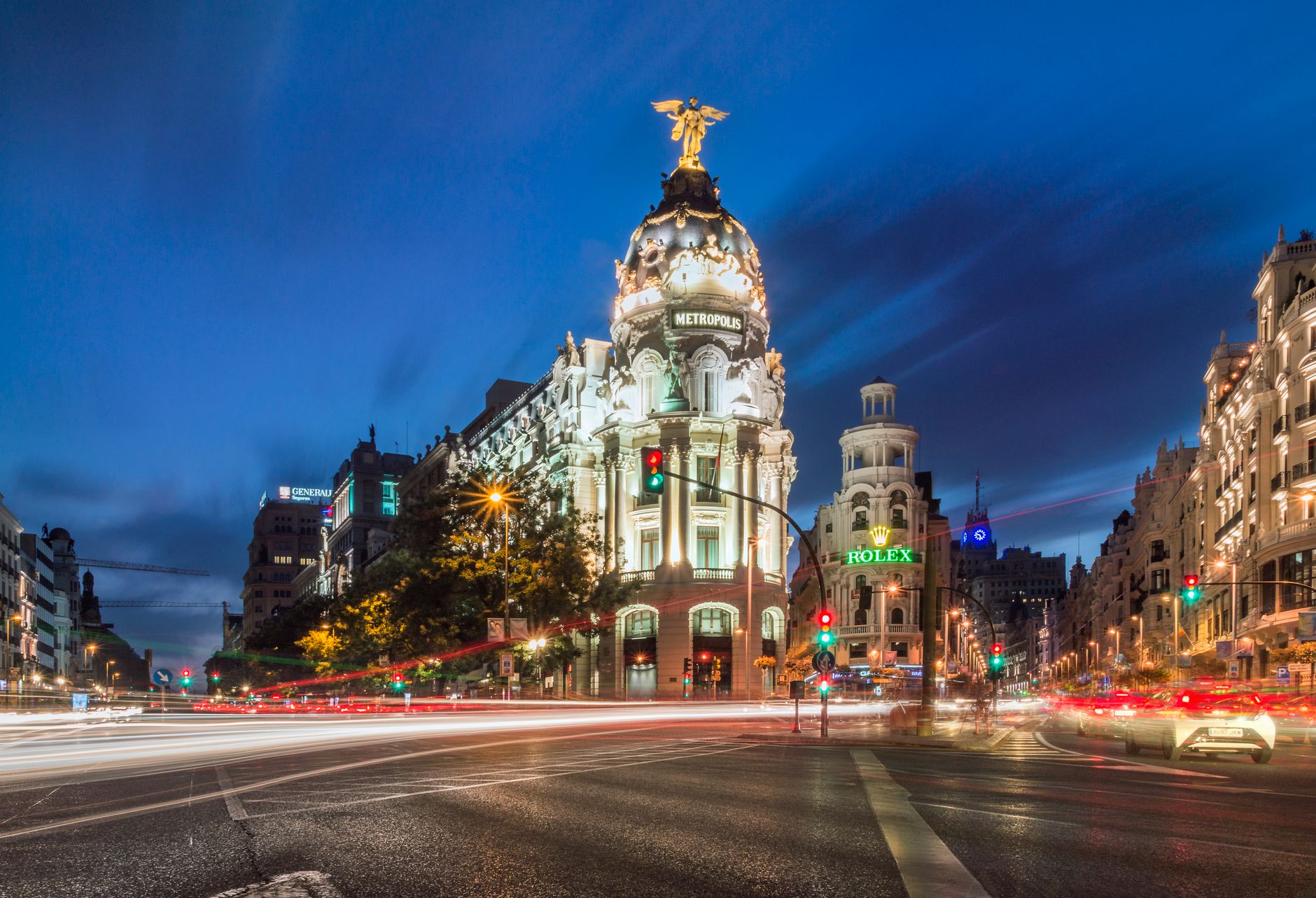 A stunning night view of the Metropolis Building with light trails and vibrant city lights in Madrid. — illustrating How Do You Plan a Madrid Day When It Rains?