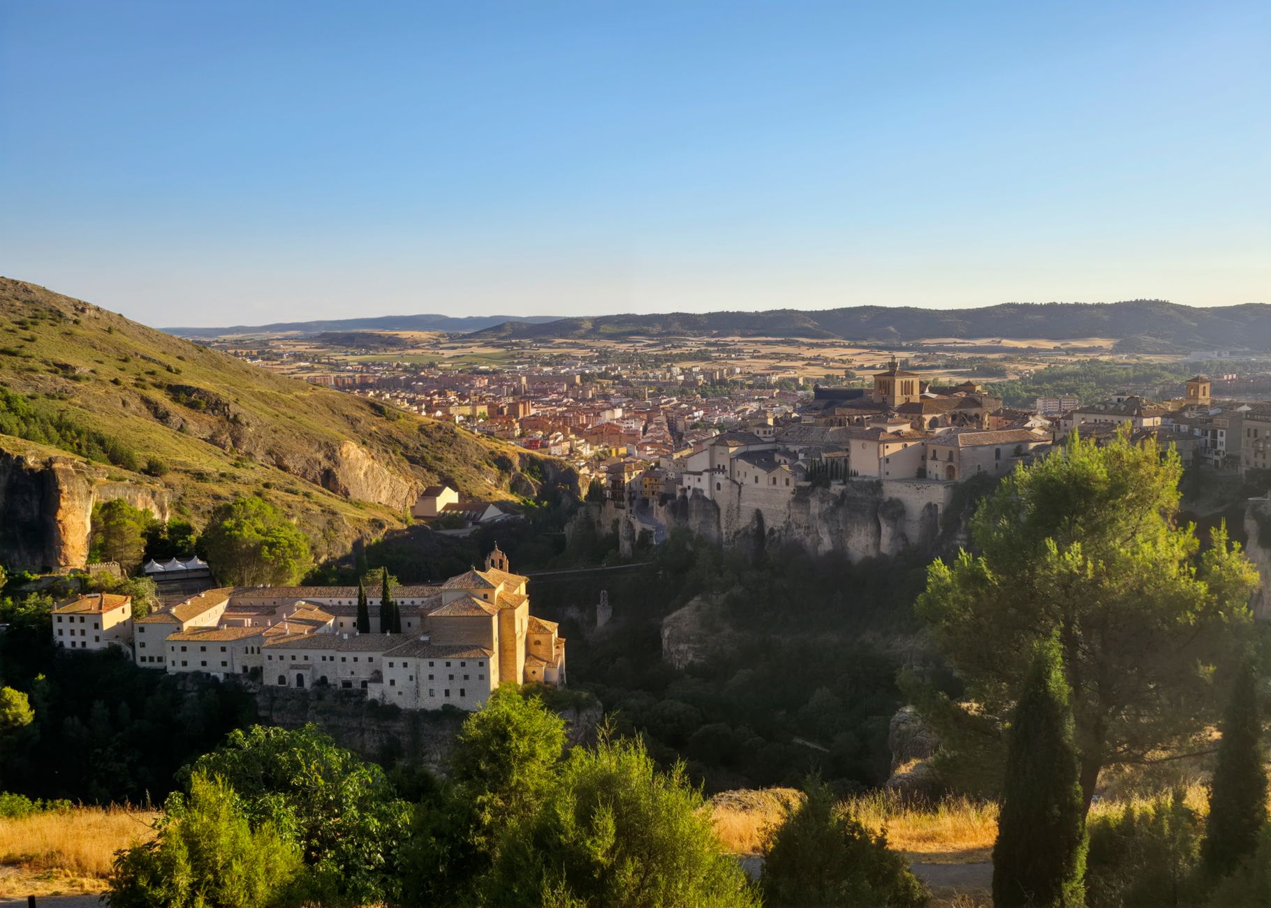 Captivating sunset view of Cuenca, Spain, showcasing historic architecture and natural beauty. — illustrating Is Cuenca a Day Trip From Madrid, or an Overnight?