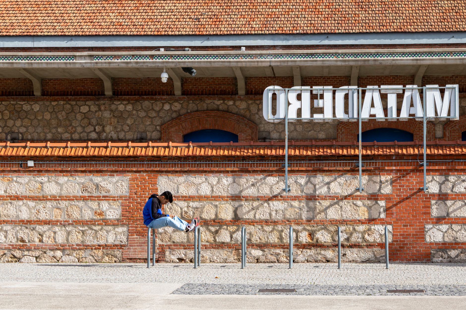 A person relaxing outside Matadero, an arts center in Madrid, Spain. — illustrating What Is Matadero Madrid, and What Was It Built For?