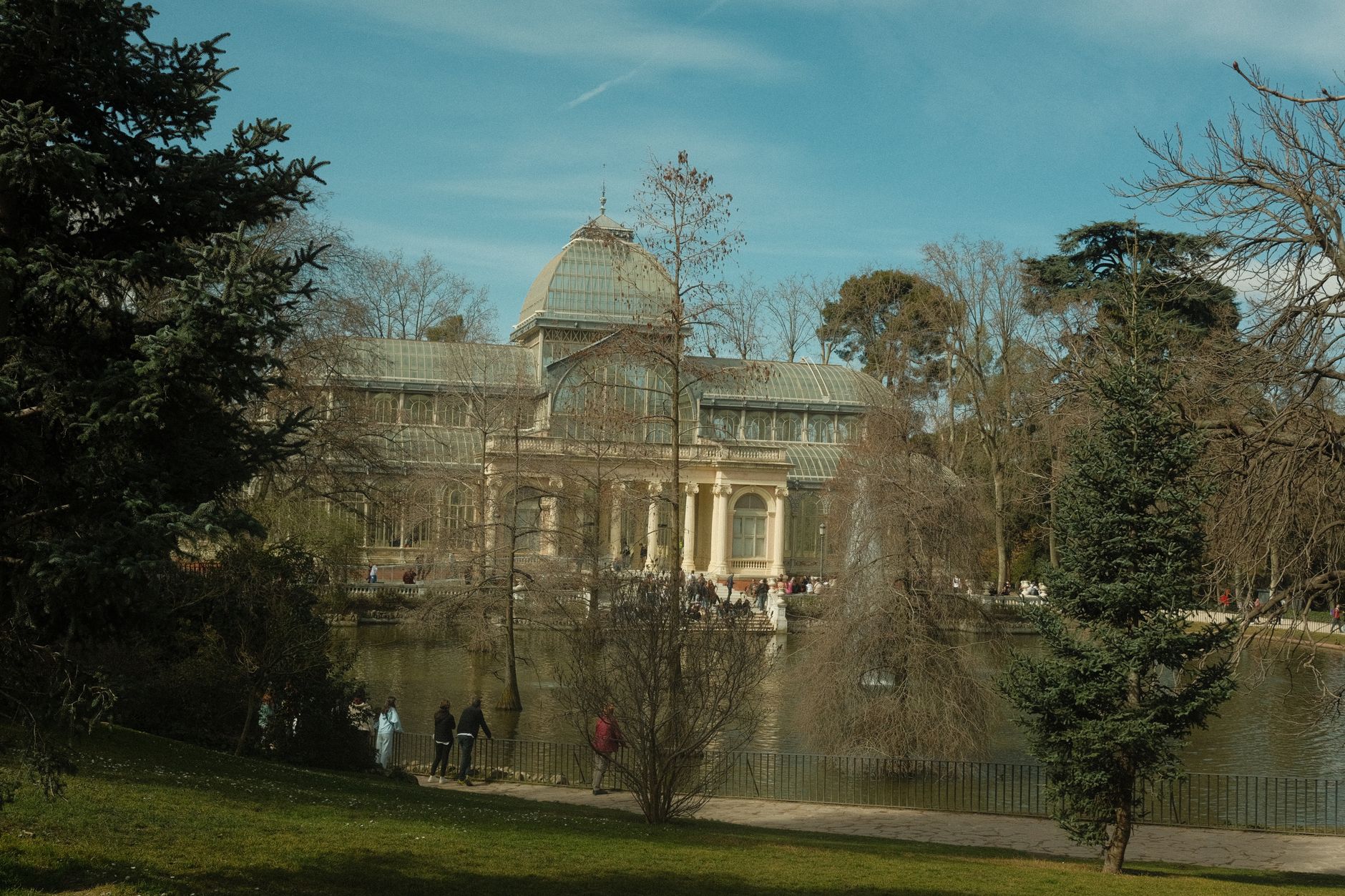 A picturesque view of the Crystal Palace surrounded by trees in a Madrid park. — illustrating What Is the Parque del Oeste? Madrid's Western Park