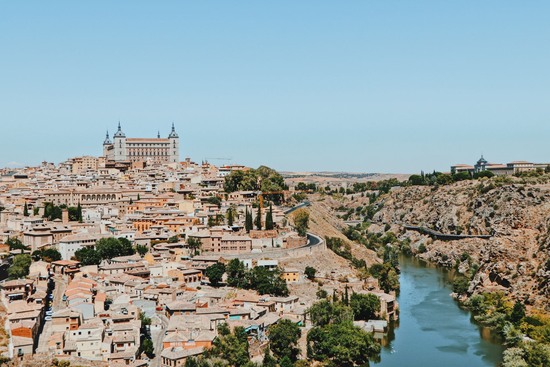 Discover Toledo, Spain's stunning view with historic architecture and the Tagus River flowing nearby. — illustrating What Is the Puerta de Toledo? Madrid's Neoclassical Gate