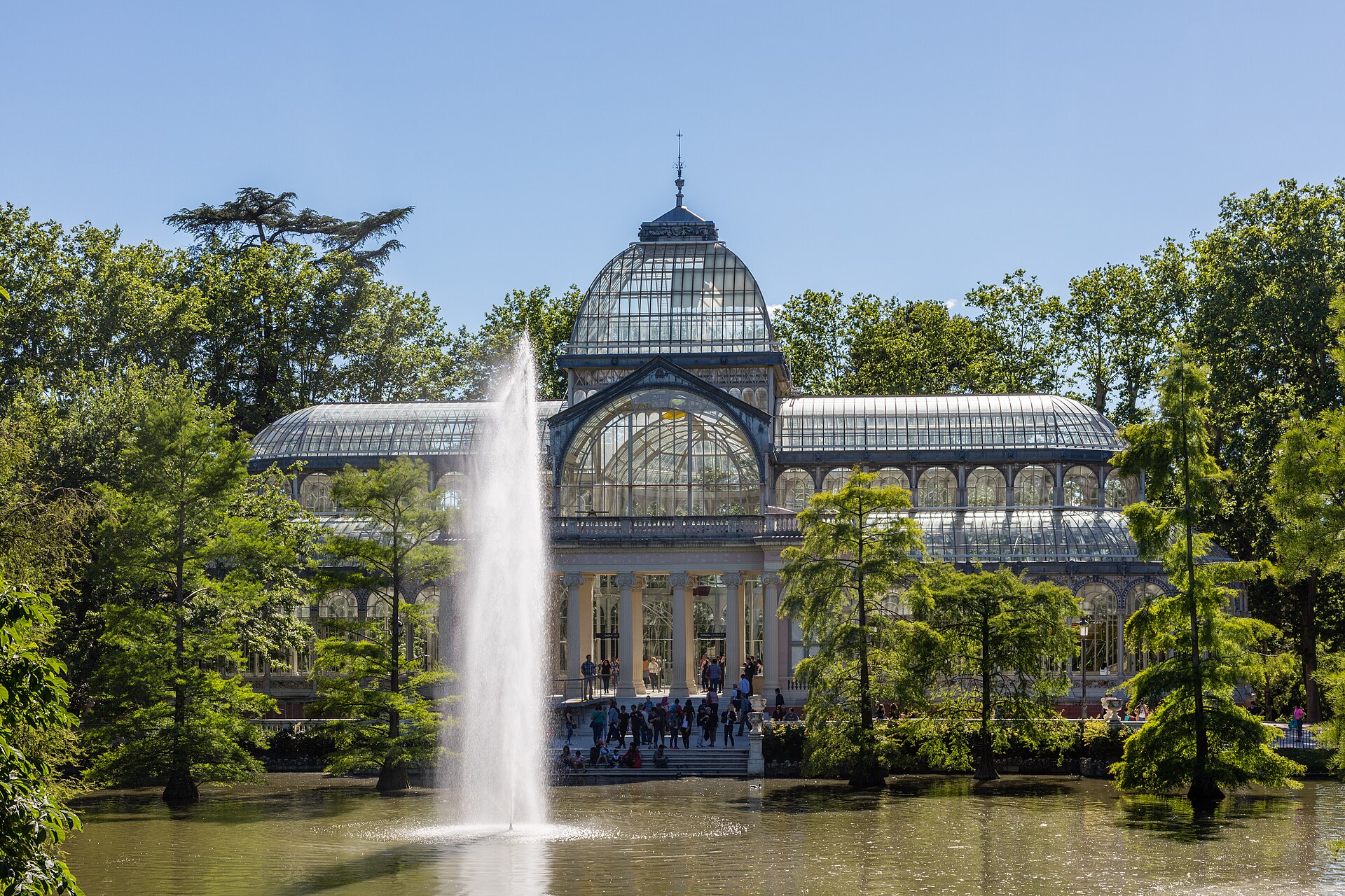 Glass and iron facade of the Palacio de Cristal in Retiro Park, Madrid