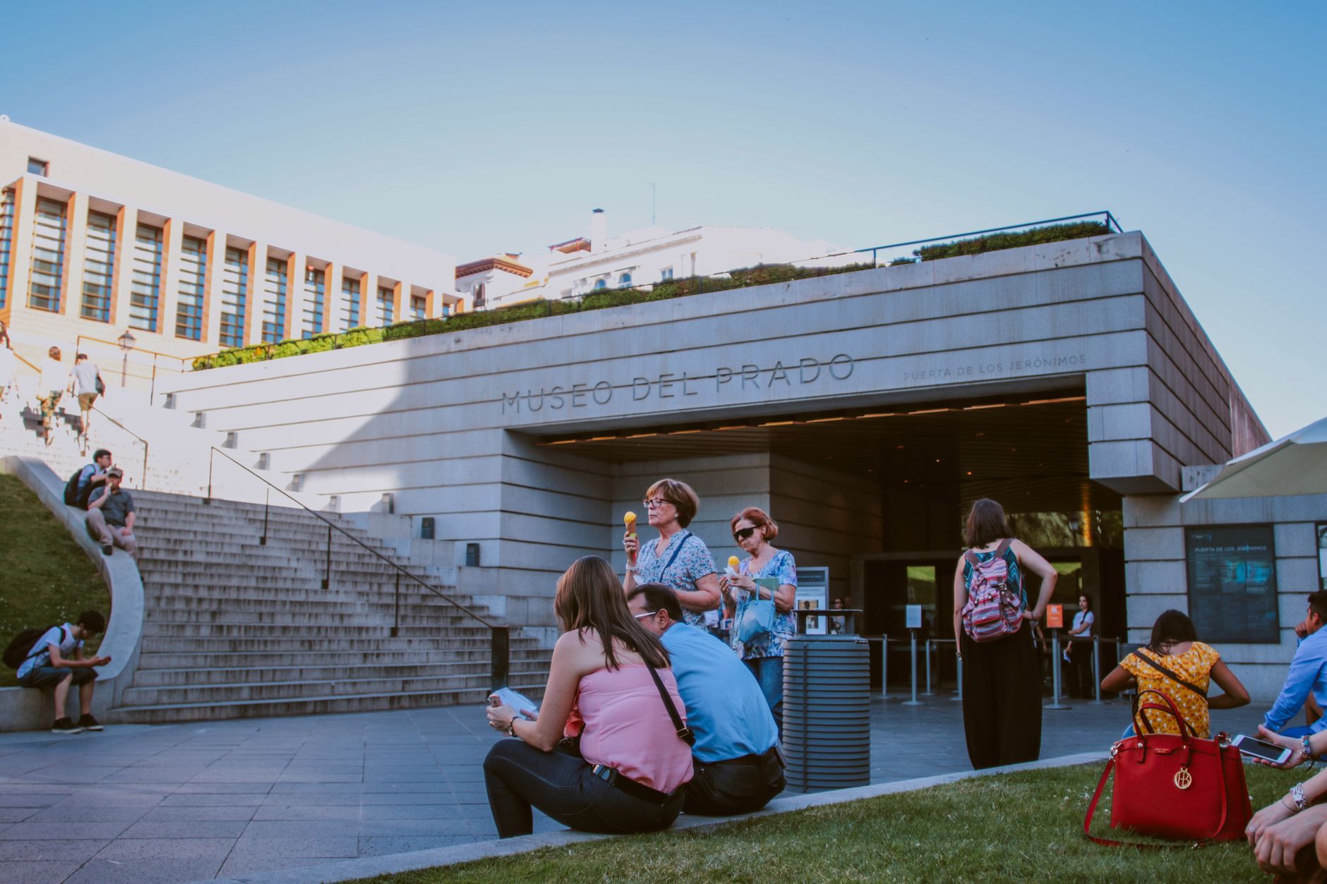 People enjoy a sunny day at the entrance of Museo del Prado in Madrid, Spain. — illustrating What Is in the Reina Sofía, and How Did Guernica Arrive?