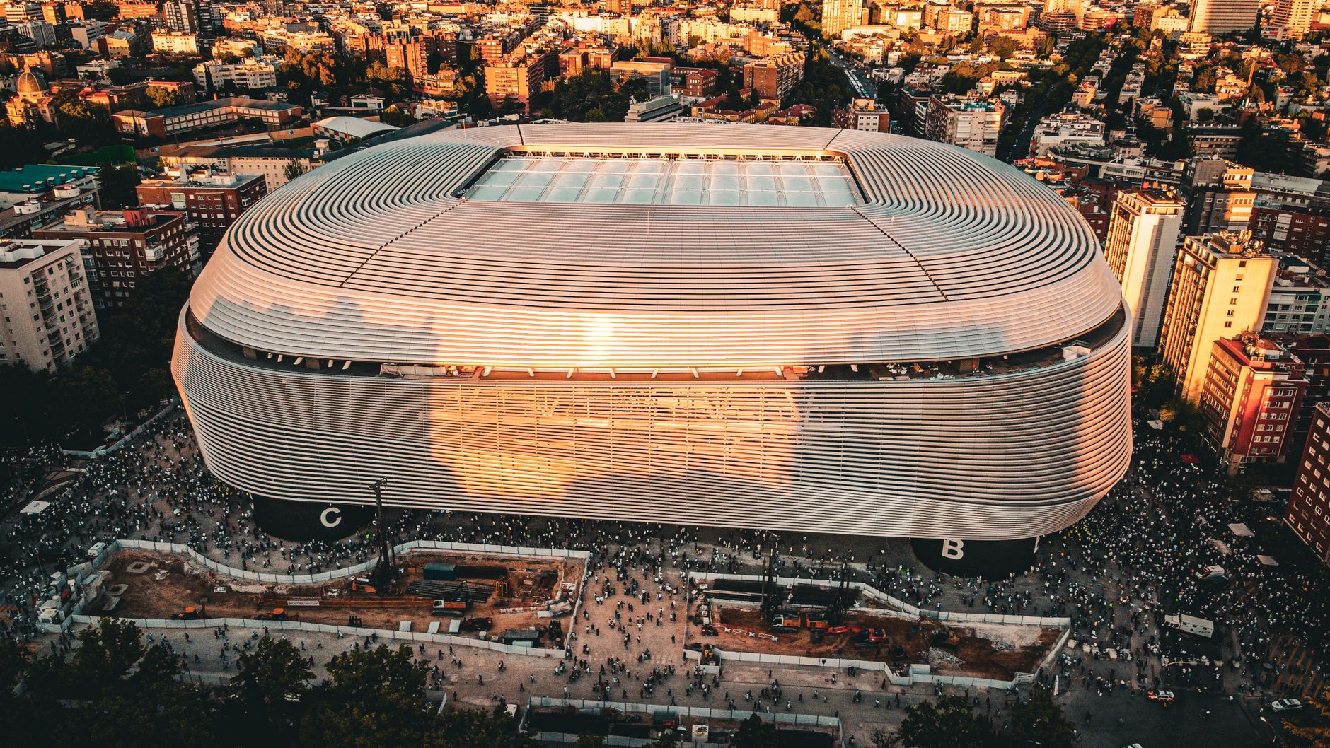 Stunning aerial shot of the Santiago Bernabéu Stadium, Madrid during sunset with bustling cityscape