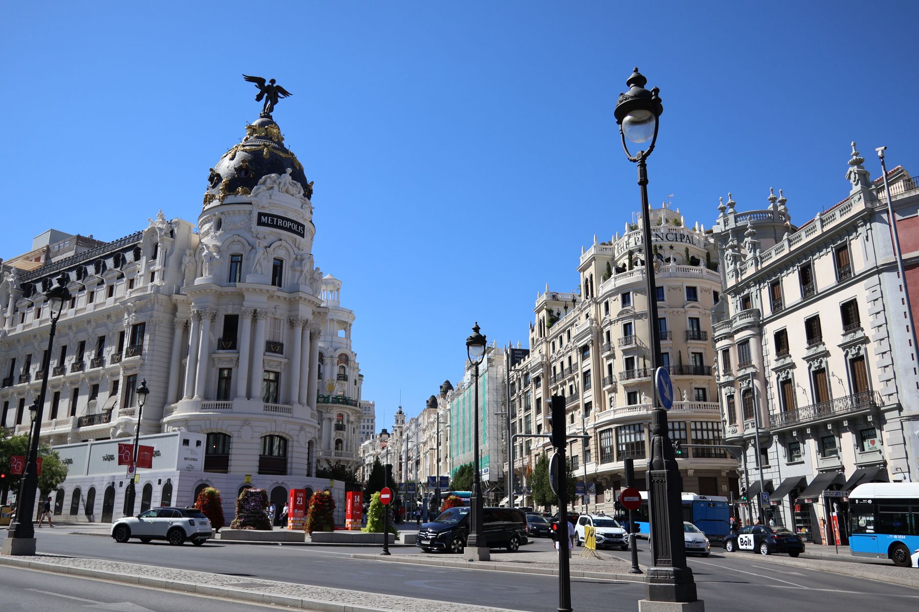 Iconic Metropolis Building on Gran Vía in Madrid under a clear blue sky.