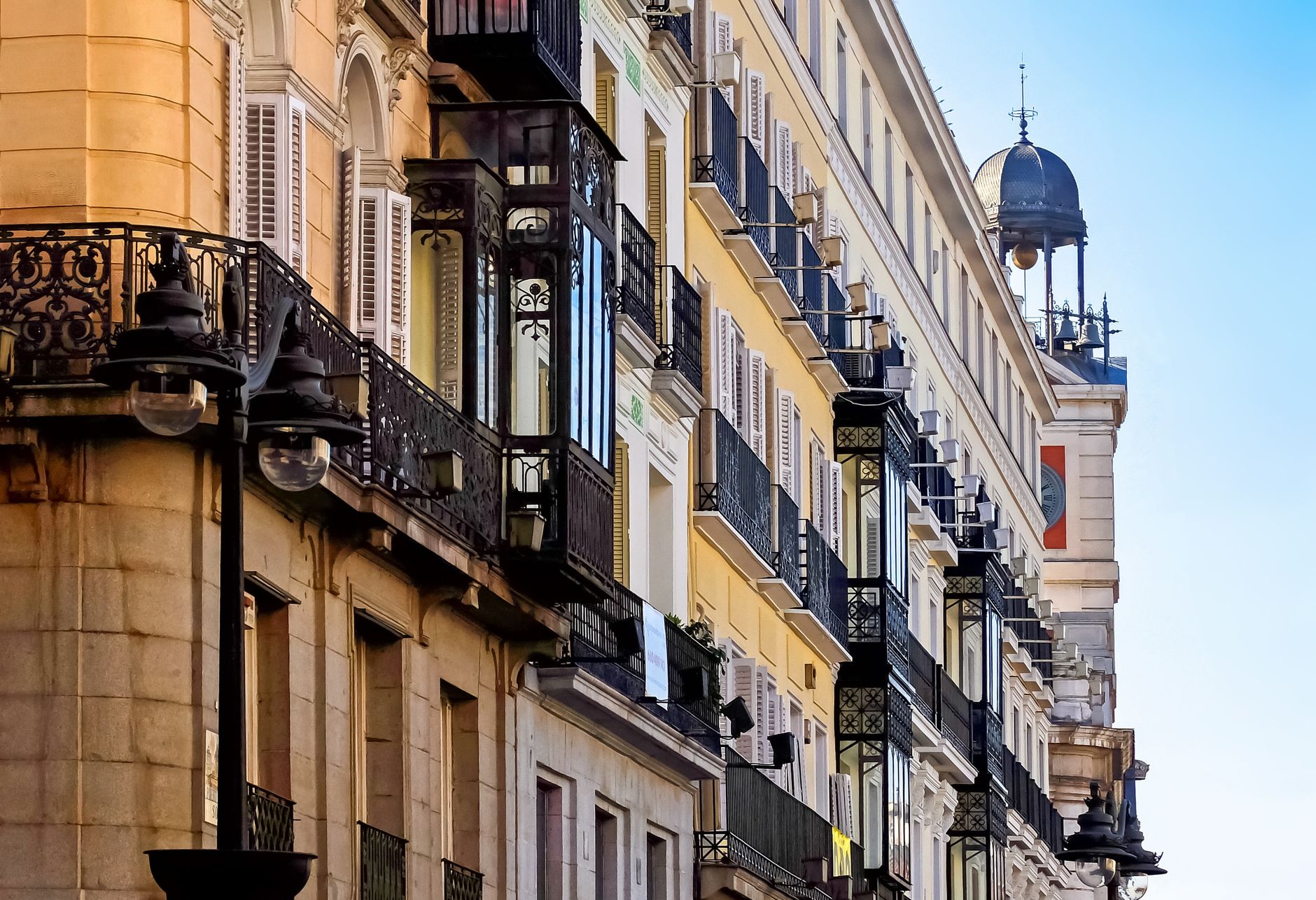 Elegant historic buildings and ornate balconies in a vibrant Madrid street scene