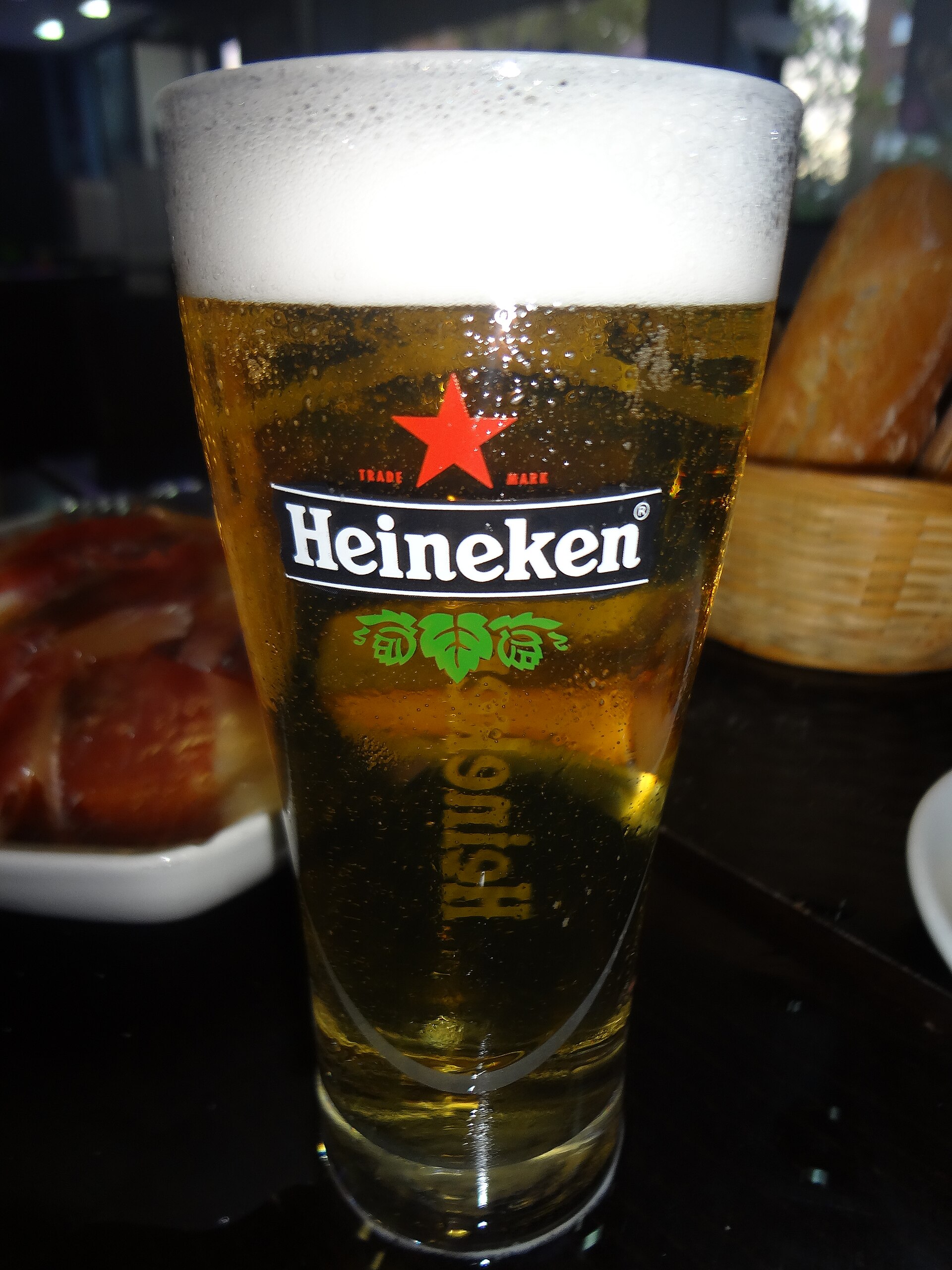 ( a plate of tapas in Madrid, Spain behind a glass of Heineken ).jpg — illustrating What Is a Tapa in Madrid, and Is It Ever Free?