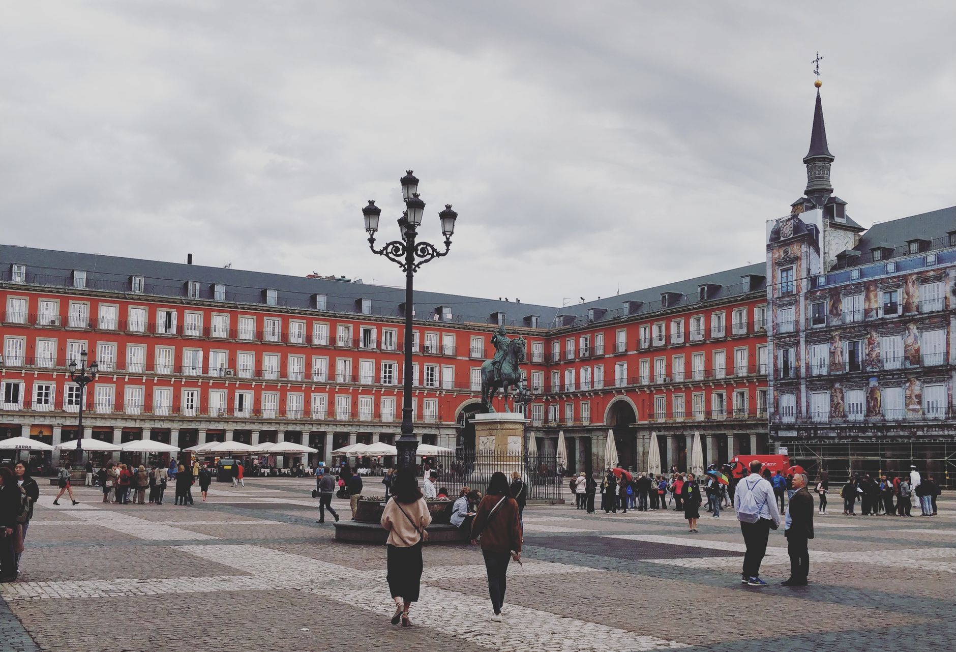 A bustling scene at Plaza Mayor in Madrid featuring the Philip III equestrian statue. — illustrating What Is Chinchón? Madrid's Plaza Mayor Day Trip