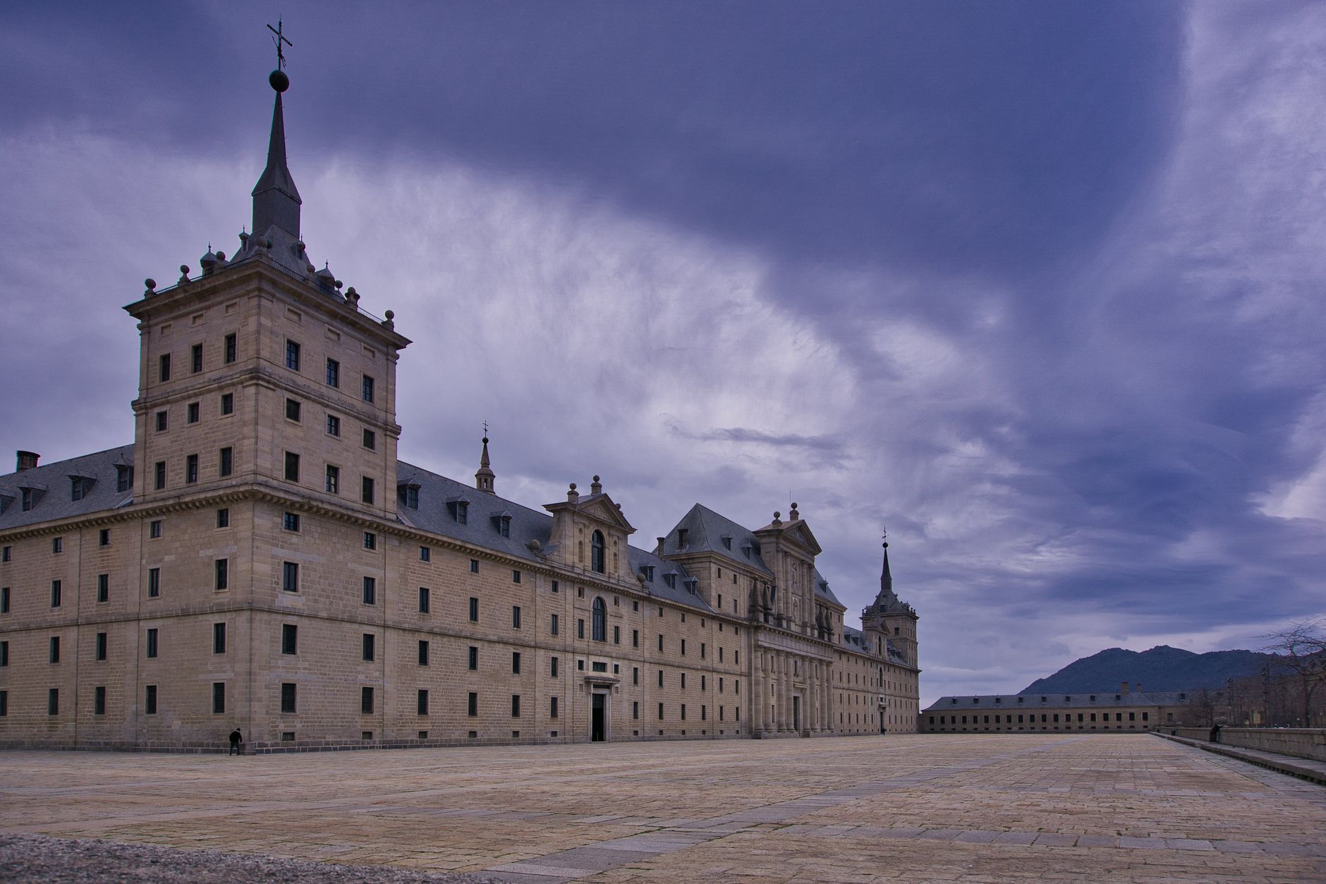 Explore the majestic El Escorial Monastery in Spain, framed by a vivid sky. Perfect for history and architecture enthusiasts. — illustrating What Is El Escorial? Madrid's Royal Mon
