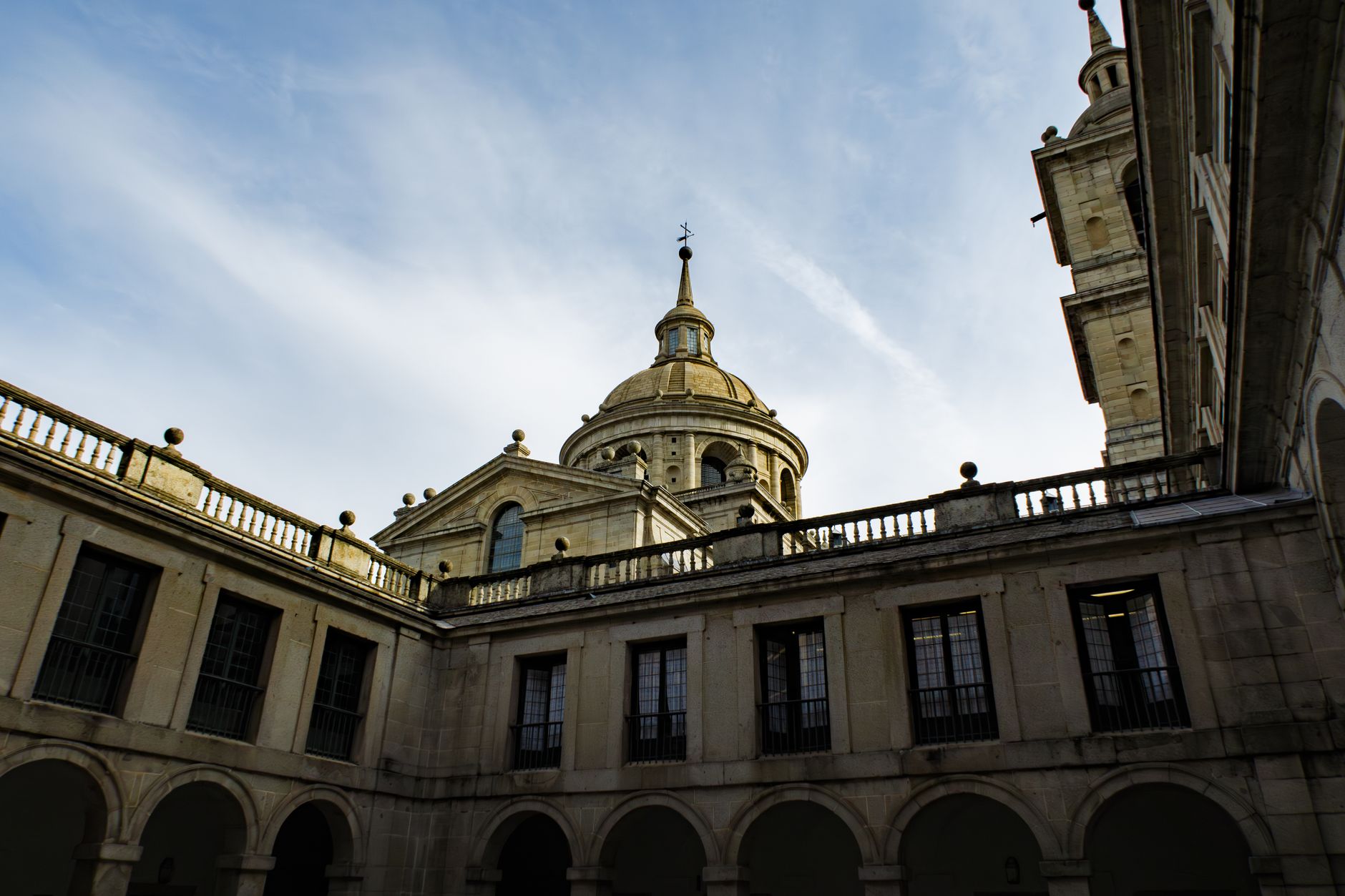 Stunning view of El Escorial's architectural domes against a clear sky in Madrid, Spain. — illustrating What Is El Escorial? Madrid's Royal Monastery Explained