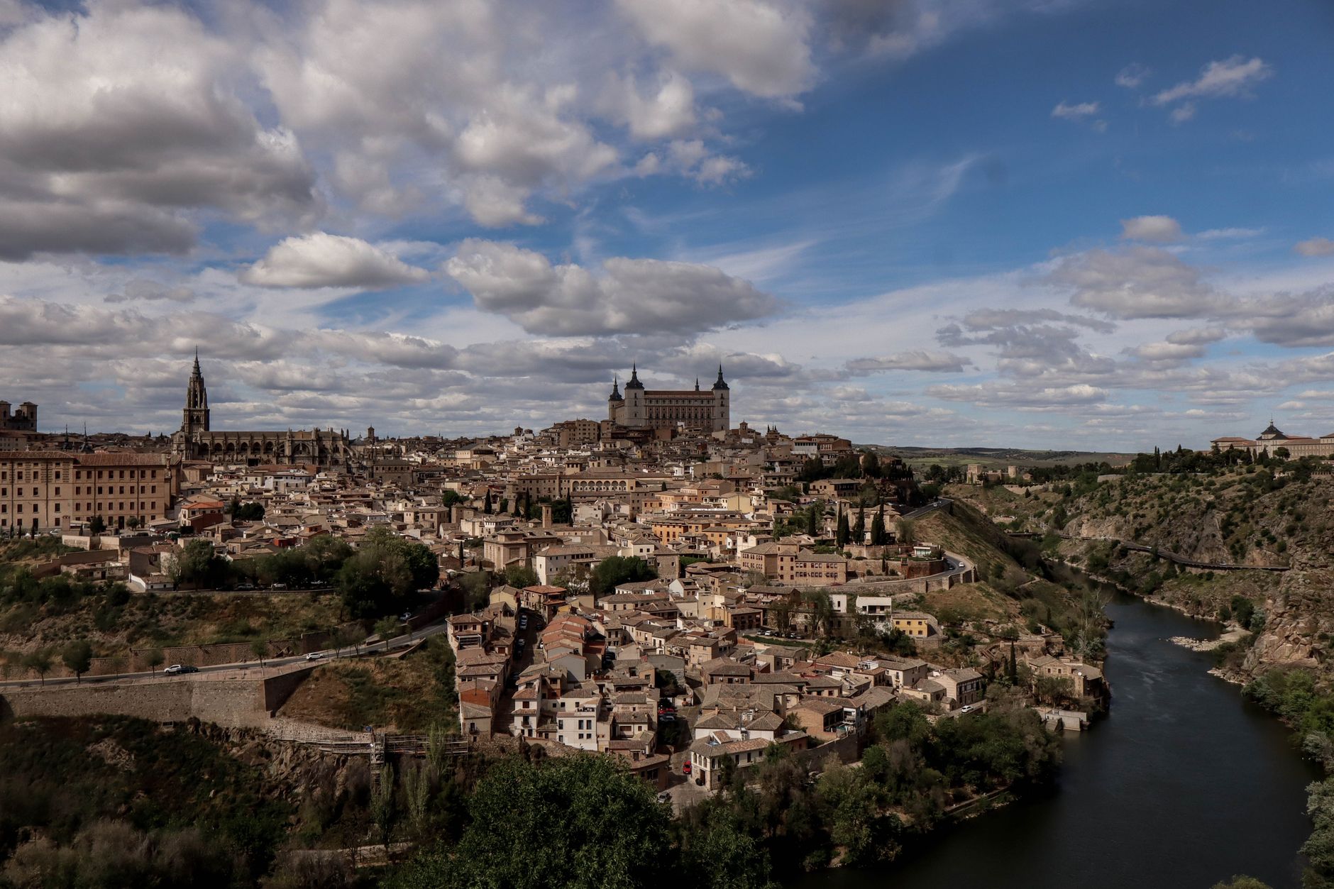 Stunning panoramic view of Toledo, Spain showcasing the Alcázar and historic architecture under a cloudy sky. — illustrating What Is Manzanares el Real? Madrid's Castle Town Explai