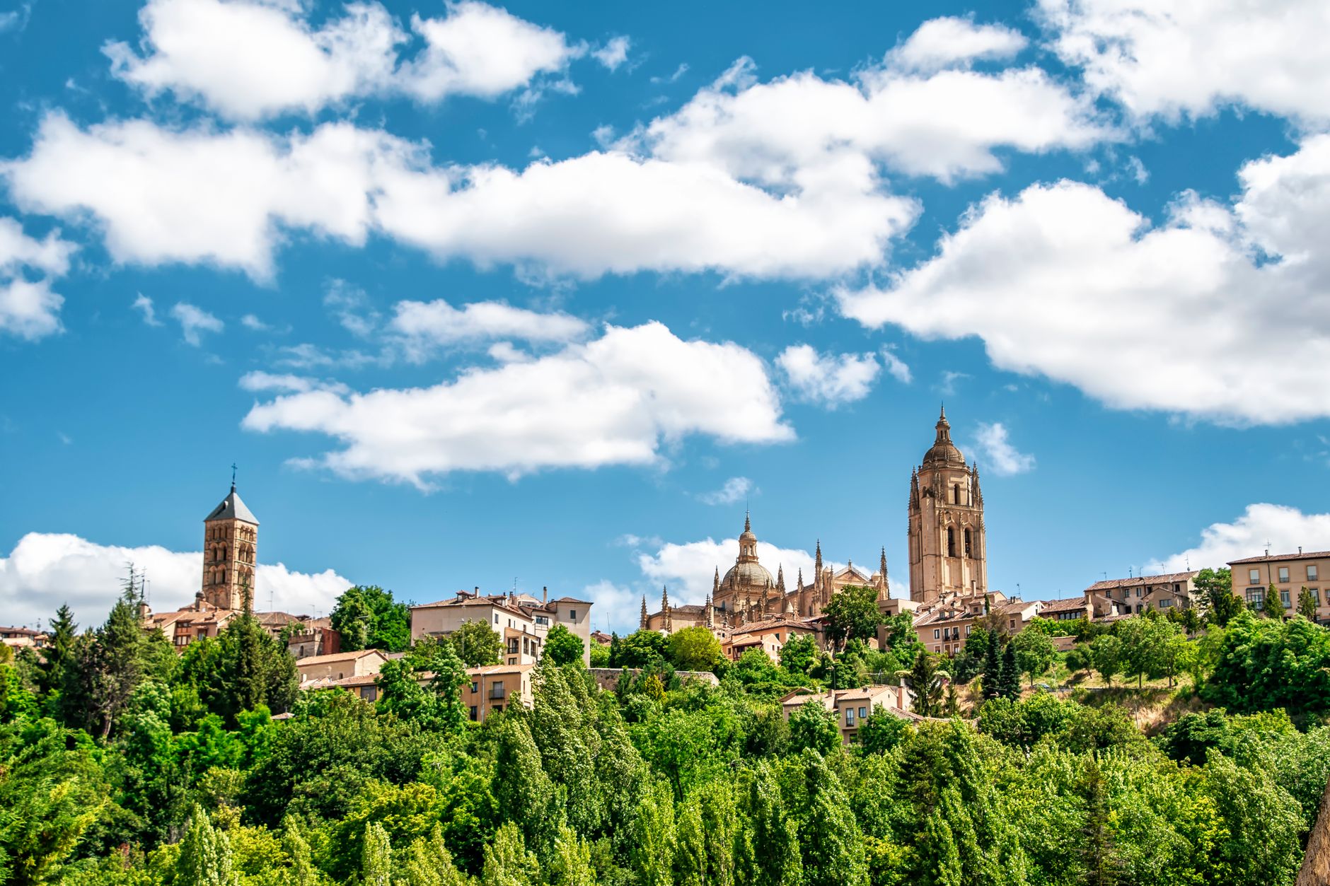 Picturesque cityscape of Segovia with cathedral towers under a vivid sky. — illustrating What Is Segovia, and What Is Its Aqueduct?