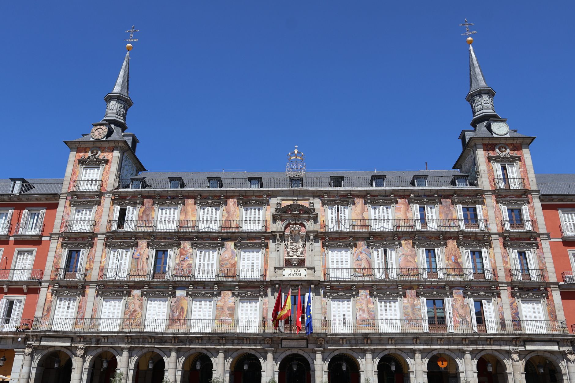 Historic Casa de la Panadería with flags at Plaza Mayor, Madrid, on a sunny day. — illustrating What Can You Do in Madrid on a Monday? A Clear Guide