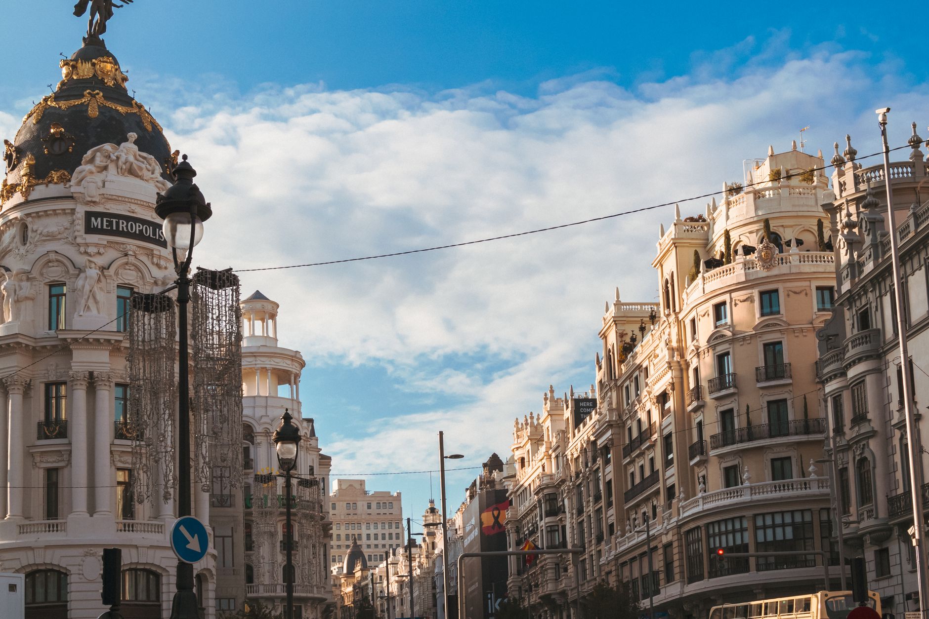 Iconic Metropolis Building on Gran Via, Madrid under a clear blue sky.