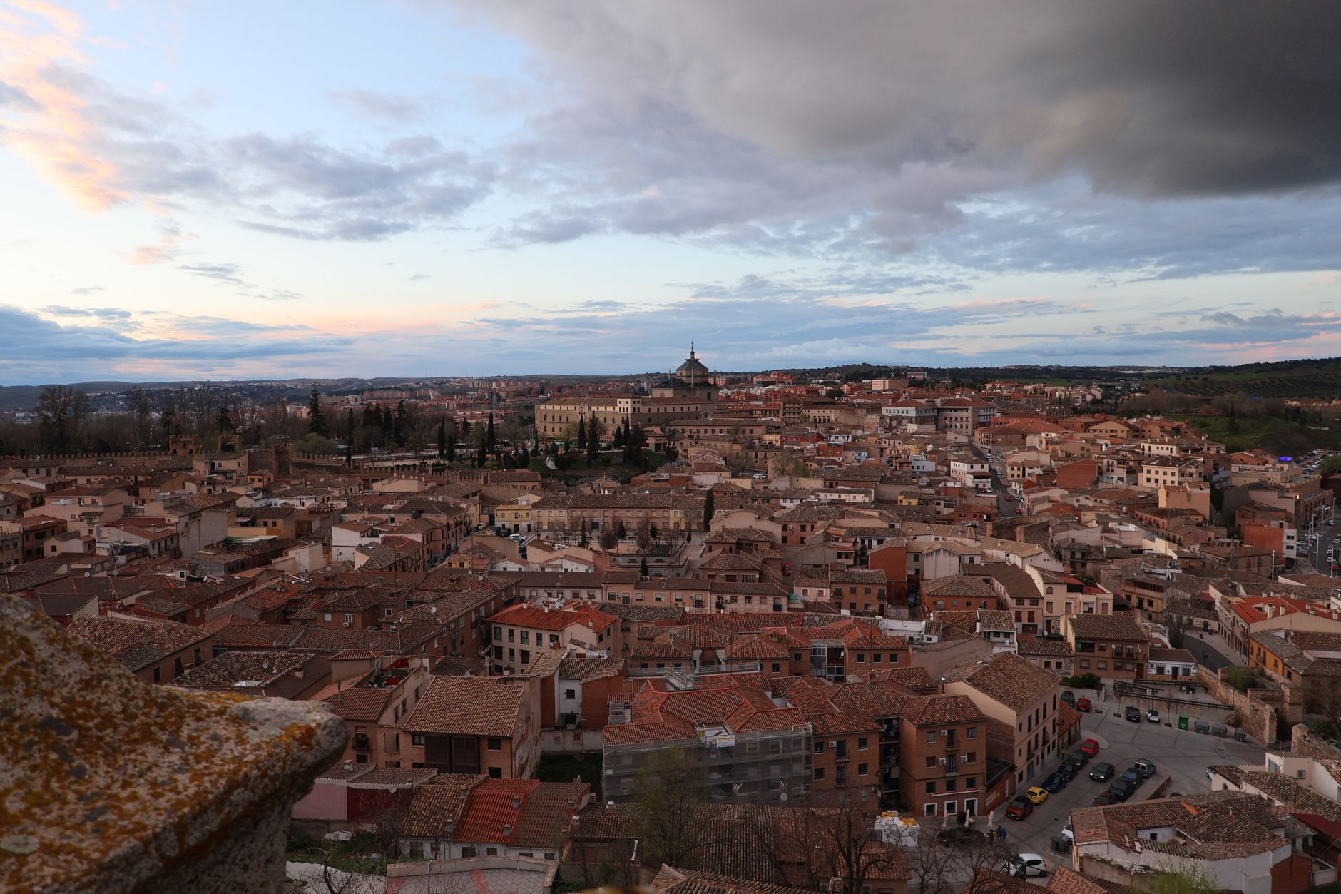 A stunning aerial view of Toledo, Spain, showcasing historic rooftops at sunset